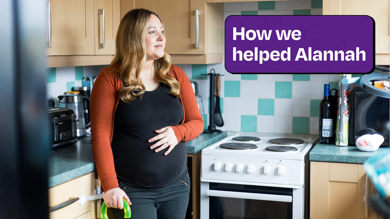 Alannah, a pregnant women holds belly and looks into distance.